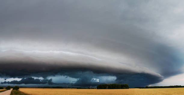 istock WEATHER - Panoramic View of Dramatic Dark Rain Clouds over Fields and Country Road. Shelf Cloud, Supercell, Cyclone, Storm, Lithuania 2161732907