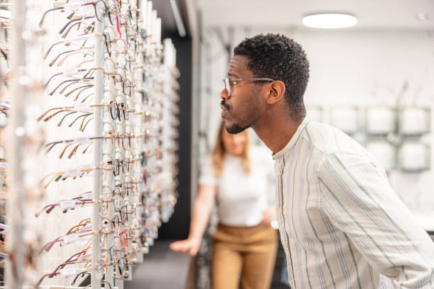 istock Mature Man Selecting Eyeglasses In An Optical Store 2161734071