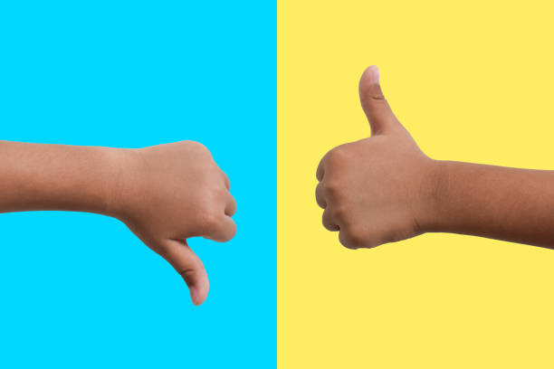 istock Child's hand shows thumbs up and shows thumbs down 2161734286