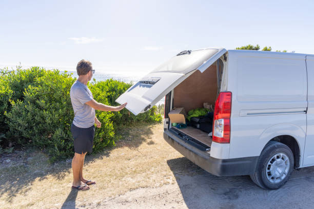 istock Man Opening Van Trunk by the Beach 2161735354