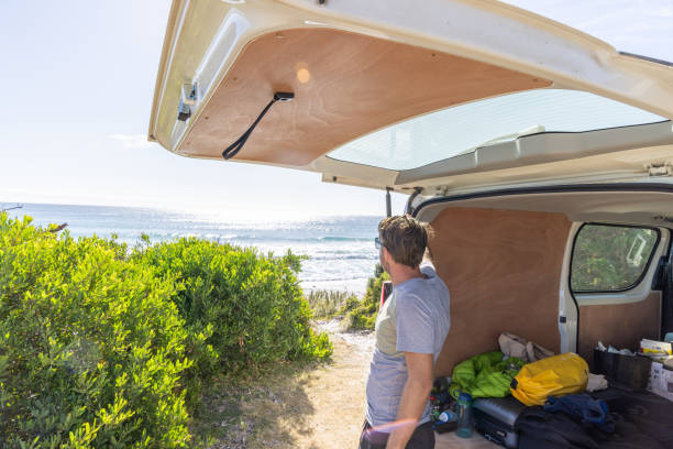 istock Man Enjoying Coastal View from Open Van Trunk 2161735489