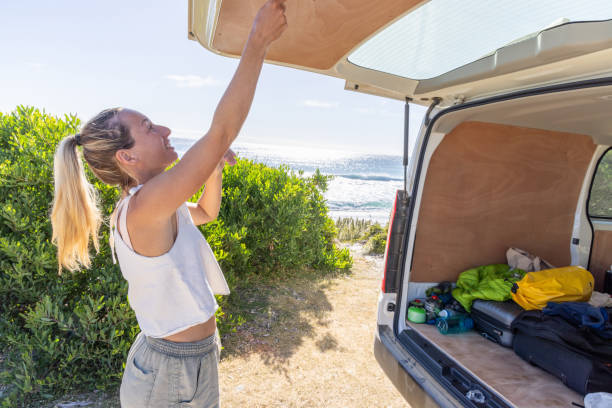 istock Woman Closing Van Trunk by the Beach 2161735952