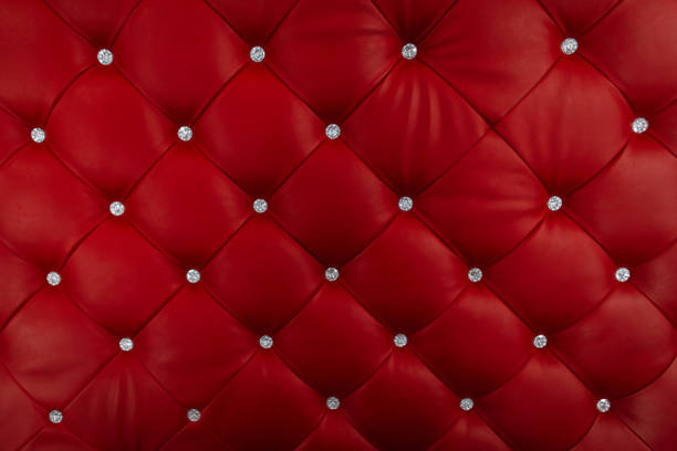 istock Closeup of a red leather sofa decorated with shiny buttons. Background. Material. 2161735971