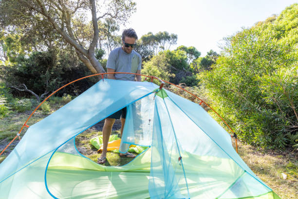 istock Man Setting Up Tent at Campsite 2161736192