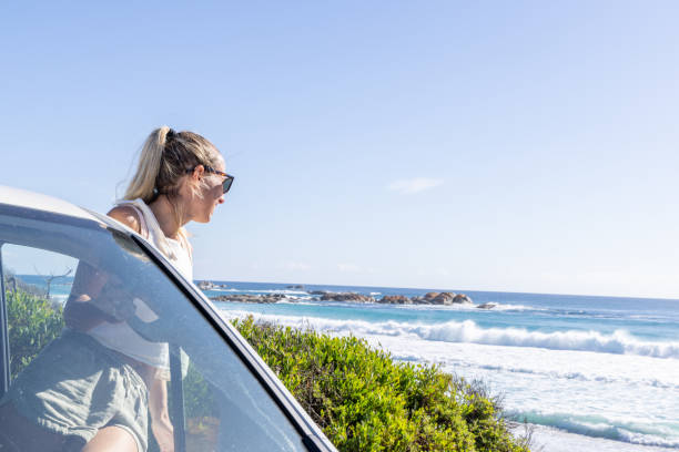 istock Woman Enjoying Scenic Ocean View from Van 2161736193