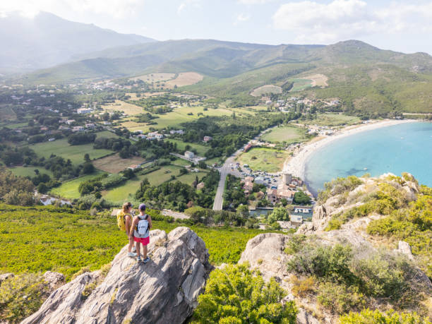 istock Friends on Cliff Enjoying Stunning Coastal Bay View 2161736362