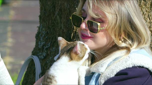 istock Young Blond Woman with a Cat in Nature 2161739719