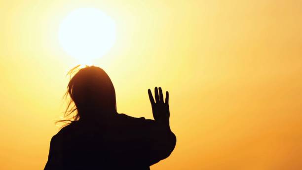 istock Young Woman Silhouette in Sunset 2161740475