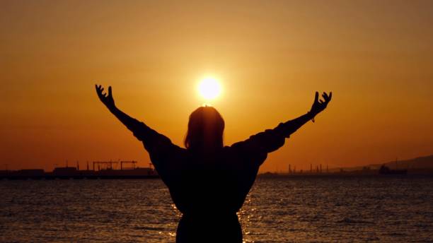 istock Young Woman Silhouette in Sunset 2161740621