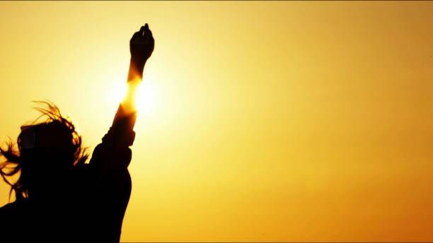 istock Young Woman Silhouette in Sunset 2161741289