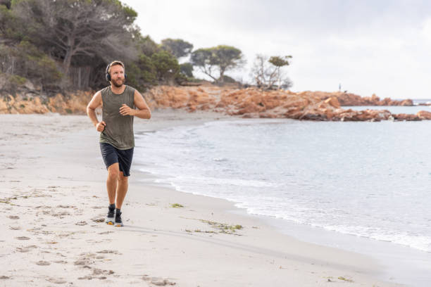 istock Morning routine, a man running by the beach 2161742318