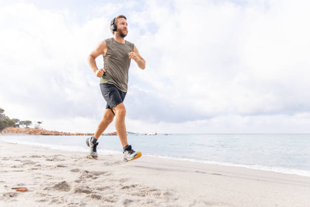 istock Morning routine, a man running by the beach 2161742514
