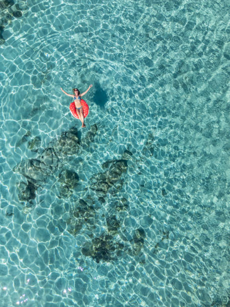 istock Woman Relaxing on a Float in Clear Waters 2161744684
