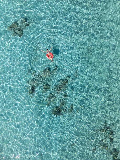 istock Woman Relaxing on a Float in Clear Waters 2161744685