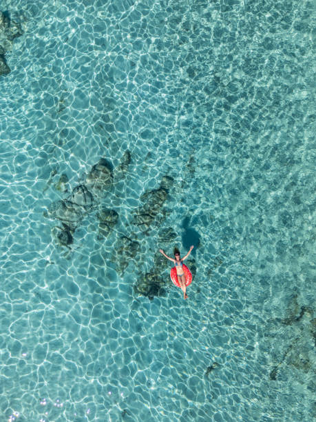 istock Woman Relaxing on a Float in Clear Waters 2161744771
