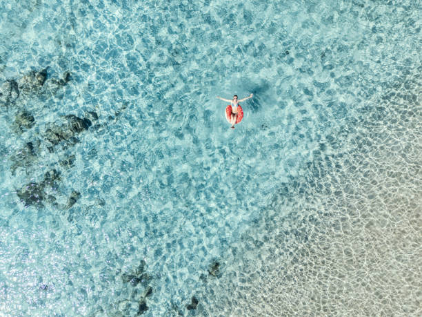 istock Woman Relaxing on Inflatable in Clear Blue Waters 2161745183