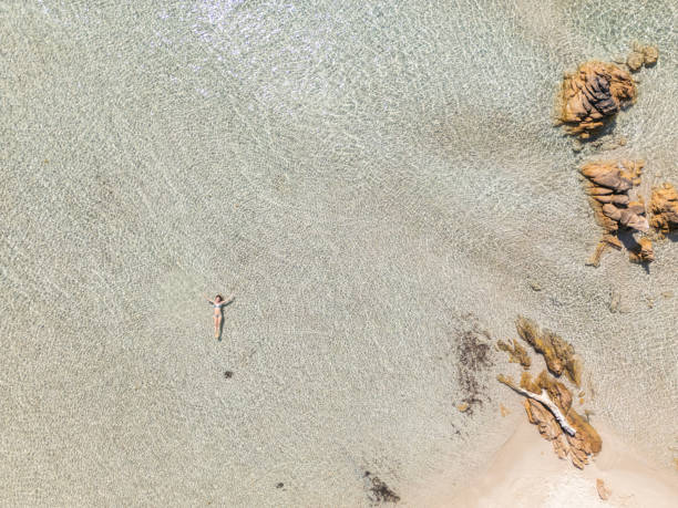 istock Person Floating in Shallow Clear Water 2161745488