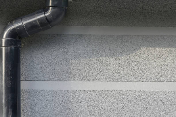 istock Rain runoff.New plastic drain pipe on a gray plastered wall 2161745678
