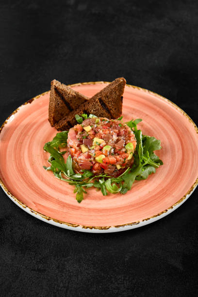 istock Fresh Tuna Tartare with Avocado on Rustic Plate with Toast Points 2161746086