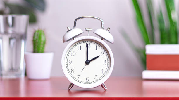 istock Classic white clock on a table. The clock hand points at 2, 14 close up photo 2161748024