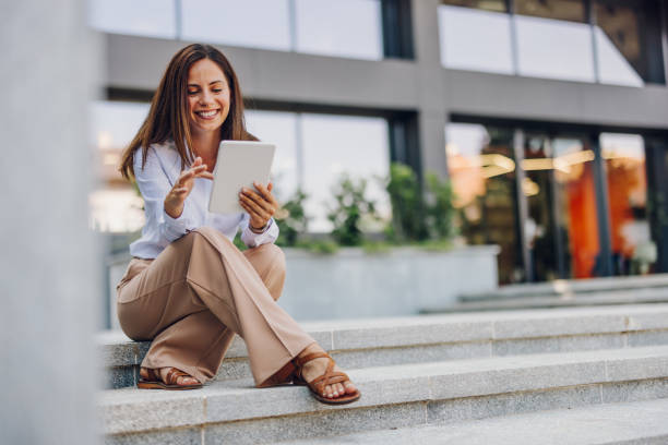 istock Young Professional Woman Using Tablet In Front Of The Office Building 2161748544