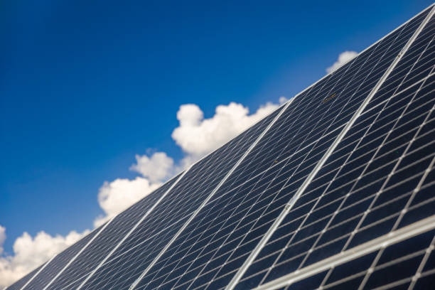 istock Tilt view solar panels under the blue sky with white clouds 2161752112
