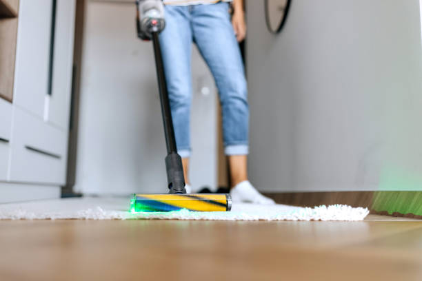 istock Unrecognisable woman using smart vacuum cleaner with dust scanner at home 2161752379