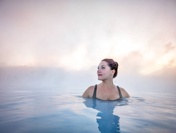 istock Woman Enjoying Tranquil Hot Spring in Iceland 2161754264