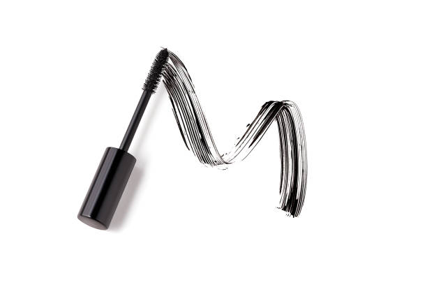 Black mascara brush stroke with applicator brush isolated on white