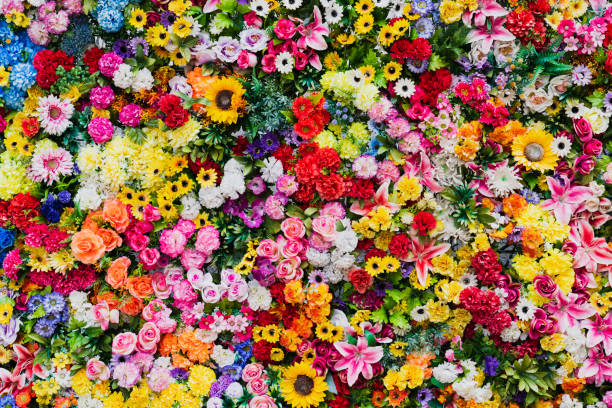 istock Photo background texture, wall made of various artificial flowers. 2161758904