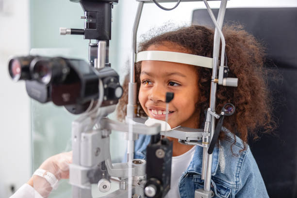 An Optometrist Checking Young Girl's Vision With Trial Frame