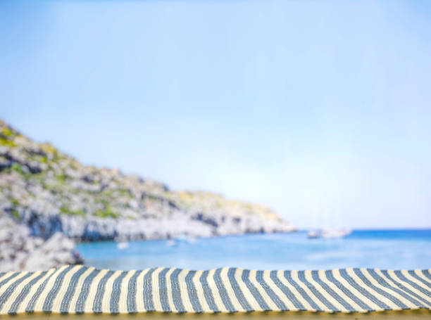 Summer beach mat on a tropical sandy beach. Seascape background. Copy space for montage products display.