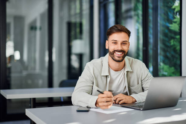 istock Portrait of a Freelance Man, working from a co-working space, alone. 2161763812