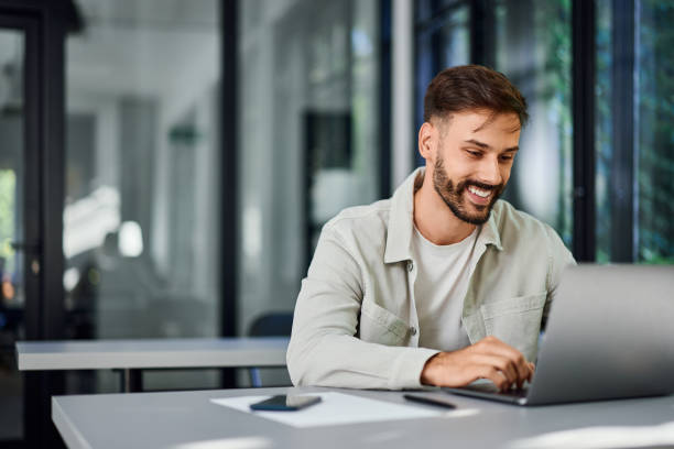 istock A smiling man working over the laptop, at the co-working space. 2161765113