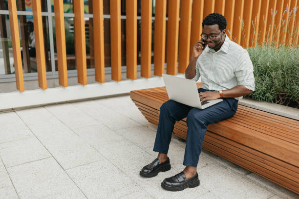 istock Professional working outside with laptop and phone 2161766530