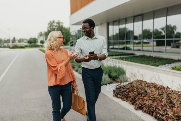 istock Business People Talking While Walking Near Office Building 2161767265