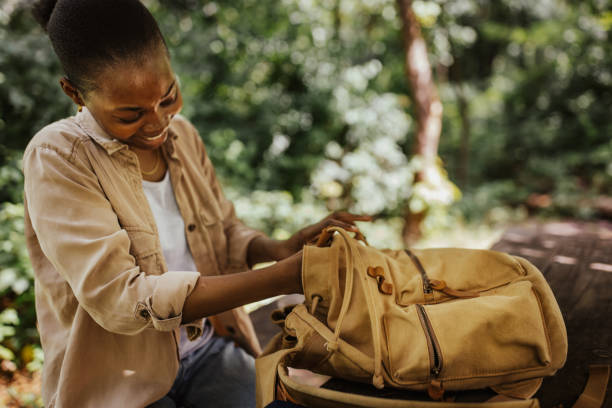 istock Person inspecting belongings inside yellow backpack 2161767629
