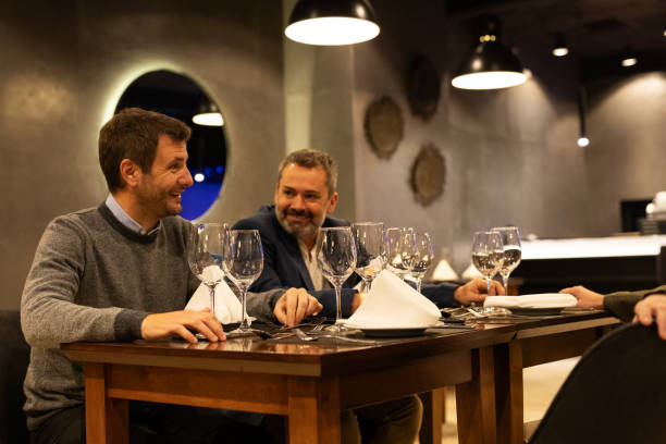 istock Three elegant male friends in a luxury restaurant 2161767698