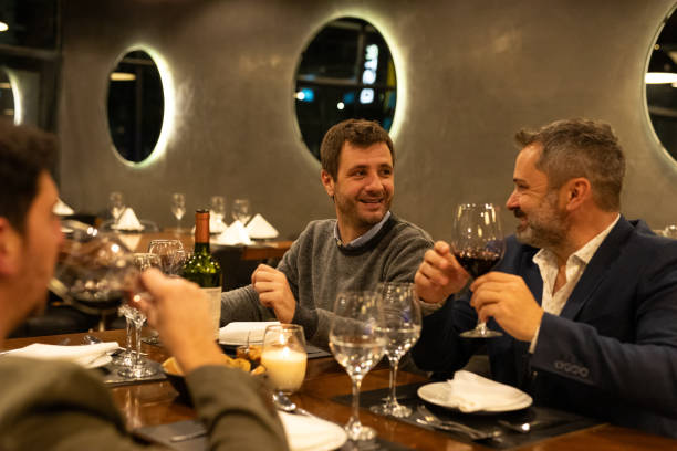 istock Male friends drinking red wine in a restaurant 2161768988