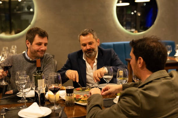 istock Male friends enjoying dinner in a restaurant 2161769137