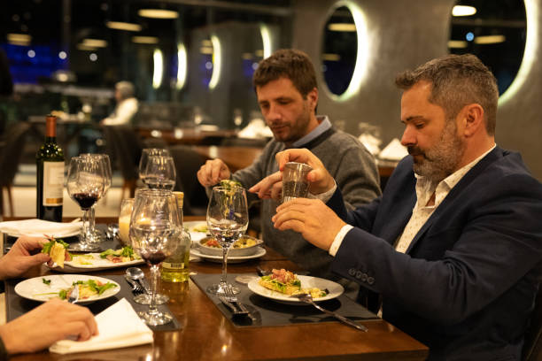 istock Male friends enjoying dinner in a restaurant 2161769261
