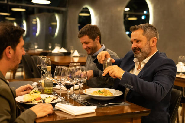istock Male friends drinking red wine in a restaurant 2161769311