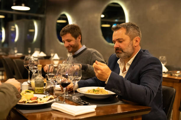 istock Male friends drinking red wine in a restaurant 2161769325