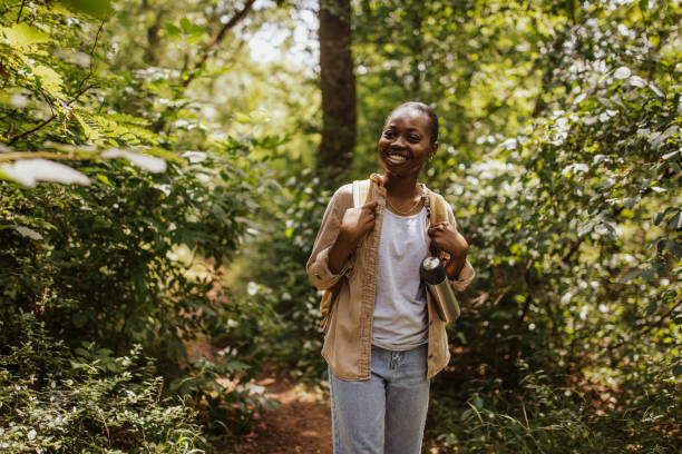 istock Woman hiking on forest path with backpack. 2161770667