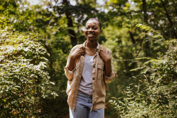 istock Woman on a green forest trail with a joyous expression. 2161770815