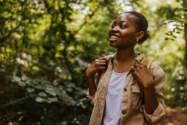 istock Woman on a hike in the woods, smiling brightly. 2161770832
