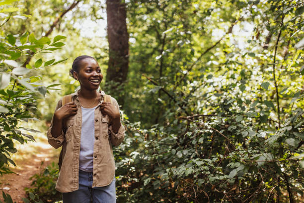 istock Young hiker in forest wearing a beige jacket and backpack. 2161771412