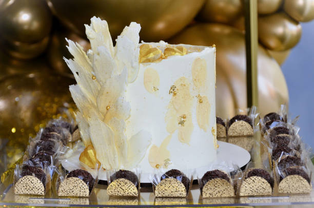 istock Thin white chocolate cake with gold surrounded by brigadeiros 2161772979