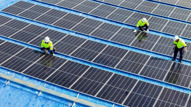 istock engineer man inspects construction of solar cell panel or photovoltaic cell by electronic device. Industrial Renewable energy of green power. factory worker working on tower roof. 2161773433
