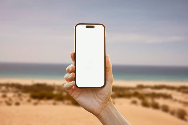 istock Young woman showing mobile phone blank white screen on Summer Background 2161774121
